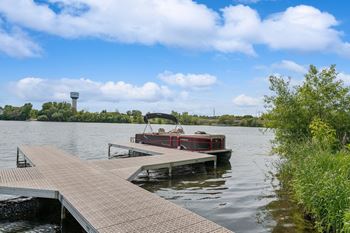 a boat is docked at a dock on a lake